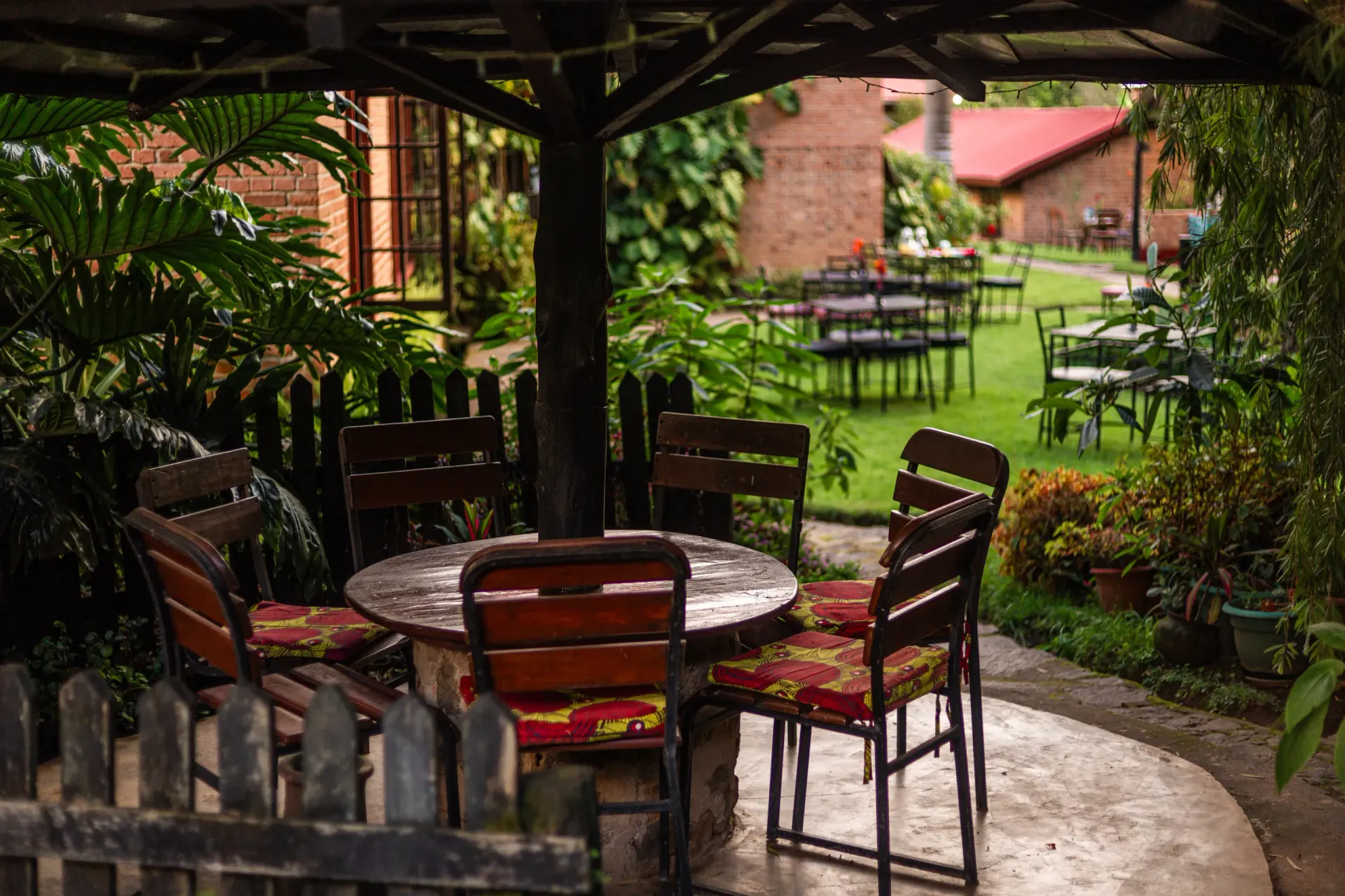A quiet sitting nook in the lodge garden, shaded by trees and looking out across the lawn