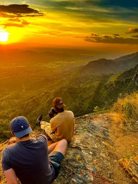 Two people watching the sunset over the valley from Irente viewpoint above Lushoto