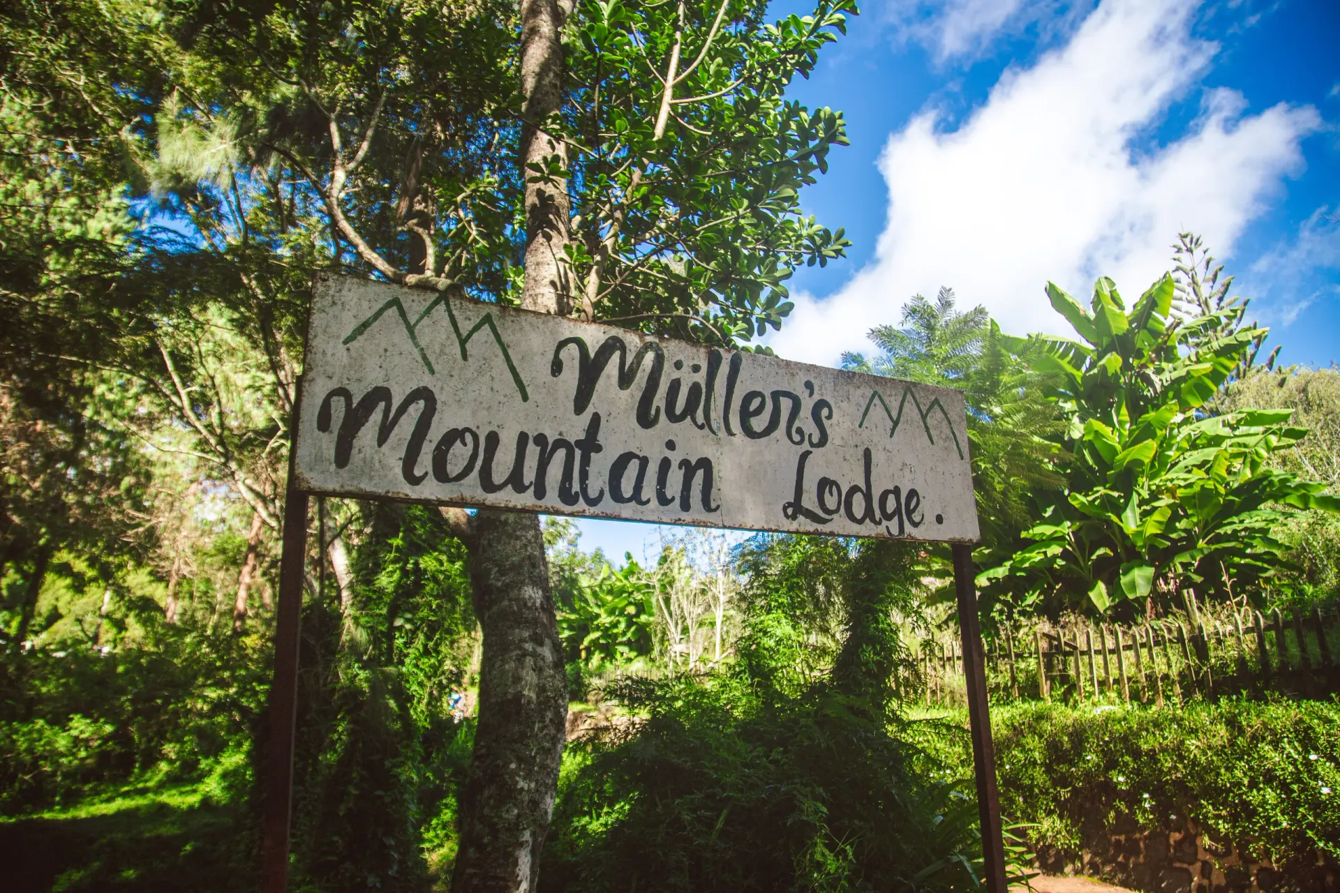 The lodge entrance and garden path at Mullers — an invitation to get in touch