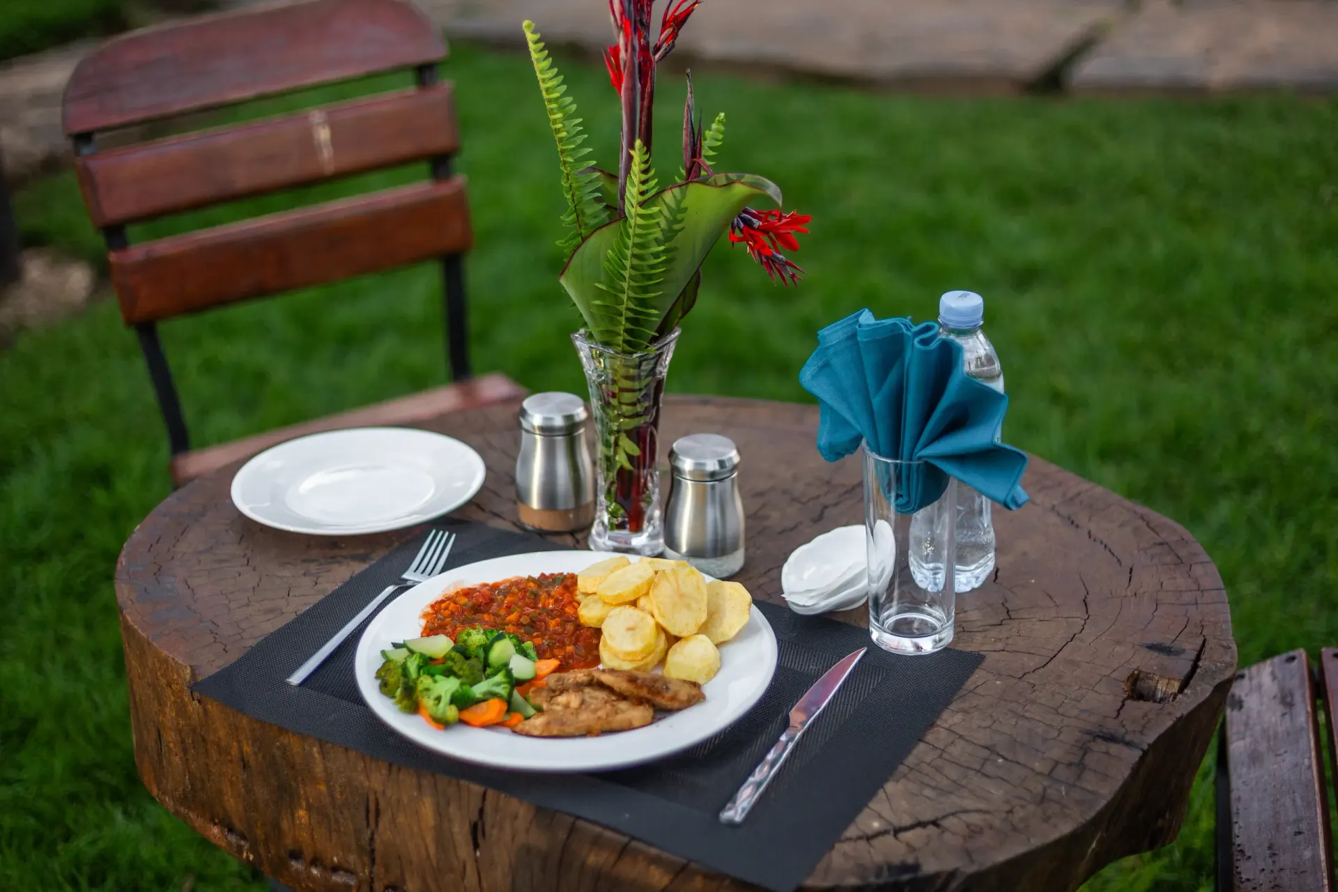 The dining experience at Mullers — table laid against the long mountain view, opening the dining page
