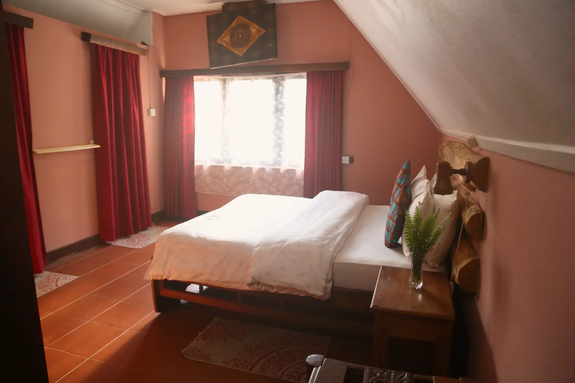 The first main-house bedroom at Mullers, dressed in warm linen